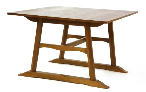 Lot 105 - An Arts and Crafts oak dining table