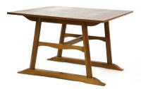 Lot 105 - An Arts and Crafts oak dining table