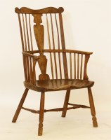Lot 618 - An early comb back Windsor chair