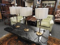Lot 208 - A pair of lacquered brass twin light tables lamps