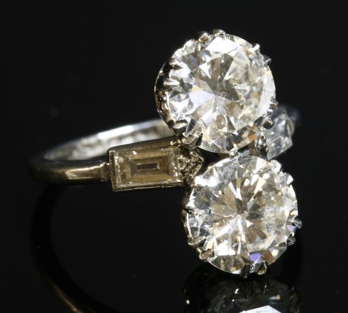 Lot 156 - An Art Deco two stone diamond fingerline ring