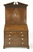 Lot 1102 - A George III mahogany bureau bookcase
