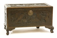 Lot 570 - A Chinese carved camphorwood trunk