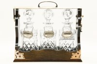 Lot 284 - A three bottle tantalus