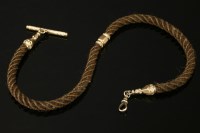 Lot 663 - A Victorian gold woven hair albert