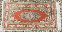 Lot 404 - A red ground Afgan rug