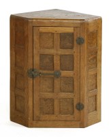 Lot 160 - A Robert 'Mouseman' Thompson oak and burr wood hanging corner cupboard
