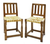 Lot 173 - Two Robert ‘Mouseman’ Thompson oak typist’s chairs