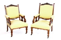Lot 738 - A pair of Edwardian his and her walnut arm chairs