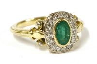Lot 12 - An 18ct gold emerald and diamond cluster ring