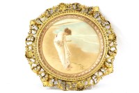 Lot 375 - A circular carved giltwood framed print of a girl on a beach