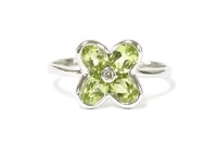Lot 42 - A white gold peridot and diamond daisy ring