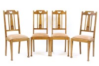 Lot 407 - A set of four Arts and Crafts oak dining chairs