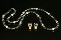 Lot 575 - A pair of 9ct gold cultured pearl and haematite figure of eight earrings