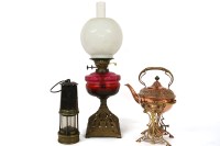Lot 250 - An Arts and Crafts embossed copper spirit kettle and stand