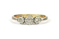Lot 29 - A gold three stone illusion set diamond ring