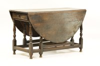 Lot 588 - An 18th century oak gate leg table