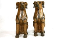 Lot 601 - A pair of carved dog ornaments