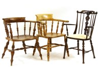 Lot 635 - A smokers bow arm chair