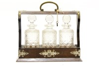 Lot 463 - A Victorian burr walnut and brass mounted gothic revival three bottle tantalus