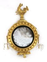 Lot 75 - A George III giltwood convex wall mirror