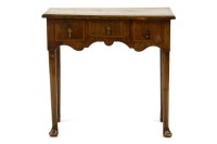 Lot 563 - A George III walnut and feather banded low boy