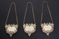 Lot 132 - A set of three hallmarked silver spirit labels