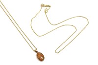 Lot 26 - A 9ct rose gold oval agate pendant