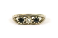 Lot 52 - An 18ct white gold three stone diamond and sapphire ring