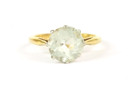Lot 41 - A gold single stone round cut aquamarine ring
