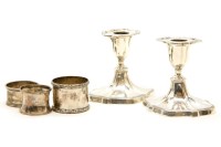 Lot 155 - A pair of silver dwarf candlesticks