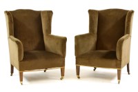 Lot 577 - A pair of Edwardian wing back armchairs