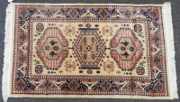 Lot 520 - A small yellow ground rug