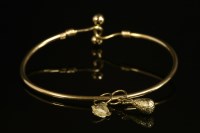 Lot 560 - A hollow tubular gold bangle