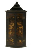 Lot 534 - An 18th century bowfront lacquered corner cupboard
