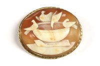 Lot 61 - A gold mounted gold shell cameo brooch