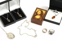 Lot 156 - A three stone silver amber cabochon pendant on chain
