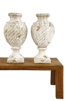 Lot 714 - A pair of distressed white painted terracotta urns