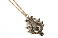 Lot 40 - A Victorian bohemian garnet set lyre and laurel pendant