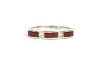 Lot 9 - A 9ct white gold diamond and cornelian half eternity ring