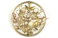Lot 22 - An Arts and Crafts style opal set circular brooch