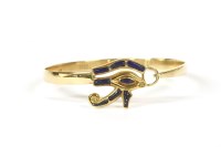 Lot 207 - A gold Egyptian flat section bangle