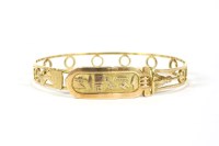 Lot 174 - A gold Egyptian flat section pierced bangle