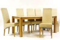 Lot 570 - An oak dining suite comprising of rectangular topped table on block supports