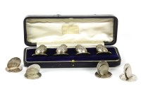 Lot 406 - An Edwardian set of four cased silver menu holders