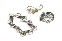Lot 23 - An Arts & Crafts silver bracelet and brooches