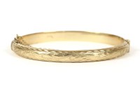 Lot 19 - A 9ct gold hollow hinged bangle