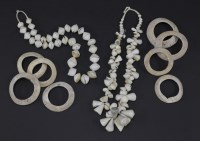 Lot 271 - TRIBAL SHELL MONEY
A group of shell money bracelets and a large string of shells