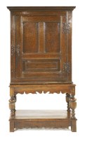 Lot 541 - An oak cupboard on stand