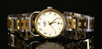 Lot 623 - A ladies' bicolour Hermès quartz 'Arceau' bracelet watch, c.1990